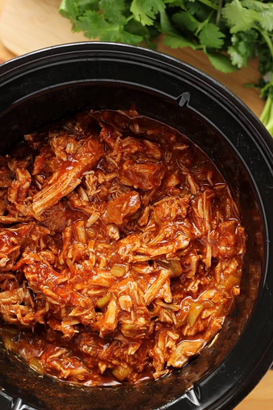 top down image of pulled pork inside a slow cooker