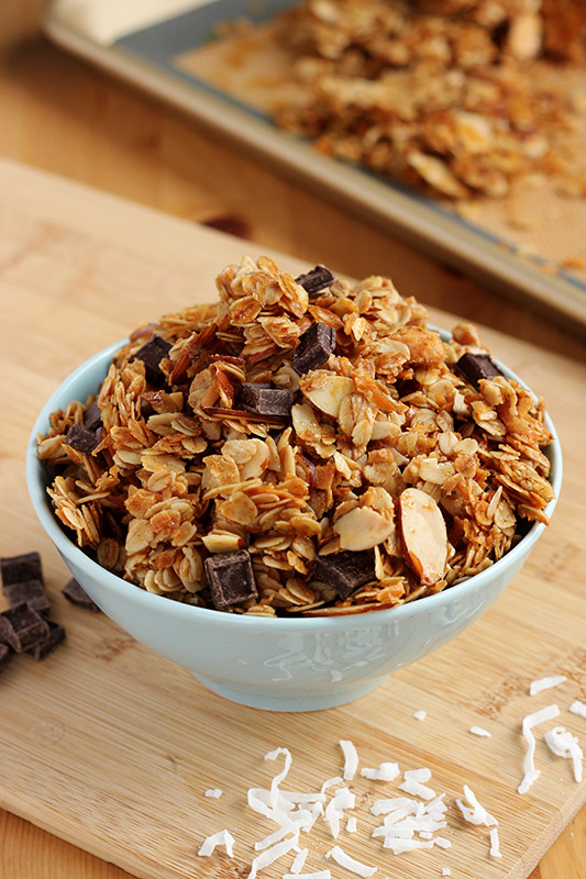 light blue bowl on a wooden table filled with homemade granola