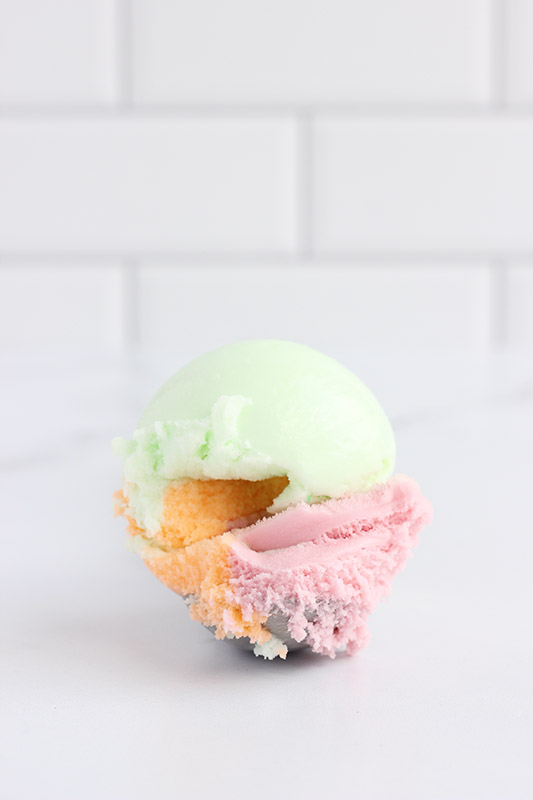 single scoop of sherbet on white background