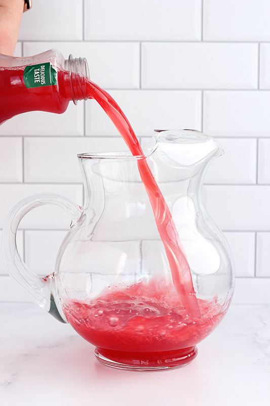 fruit punch being poured into a pitcher