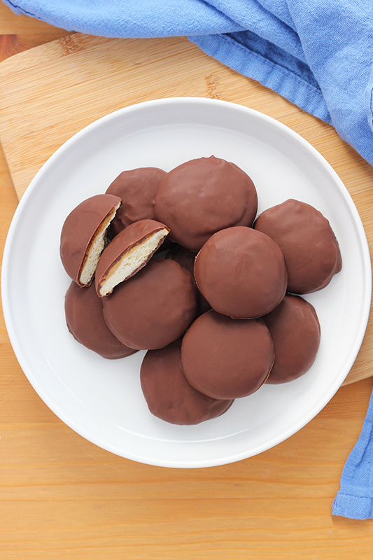 top down image of a white plate stacked with cookies, one cut in half