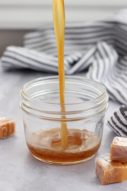 syrup being drizzled into glass jar