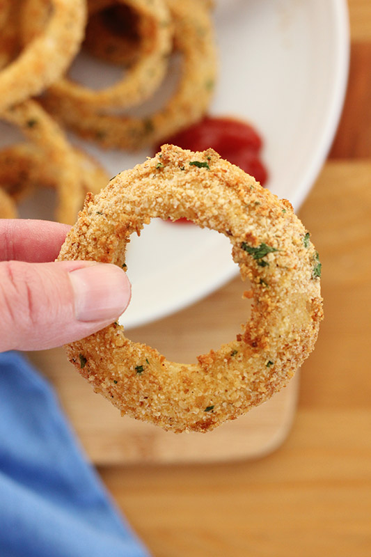 single onion ring held by hand