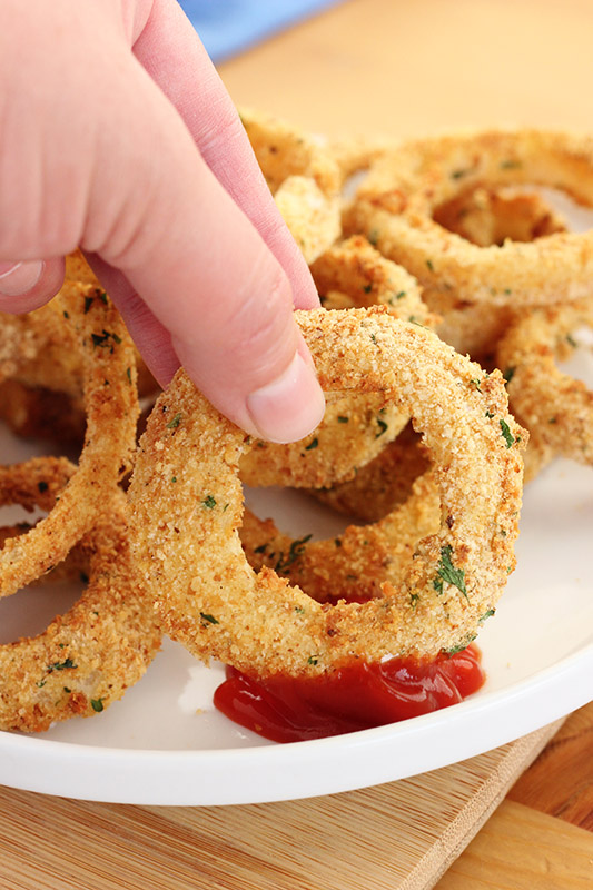 onion ring being dipped into ketchup