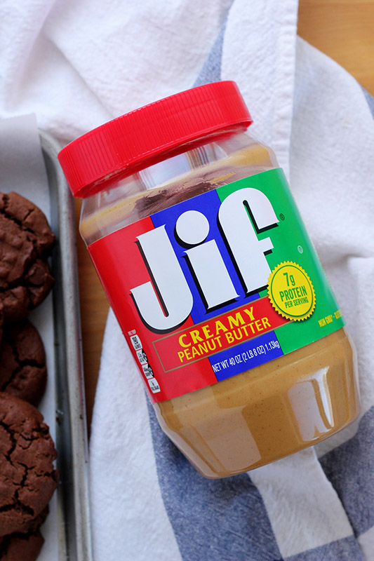 Jar of peanut butter sitting on a blue and white napkin