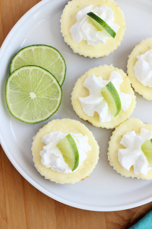 top down image of a plate filled with mini lime cheesecakes 