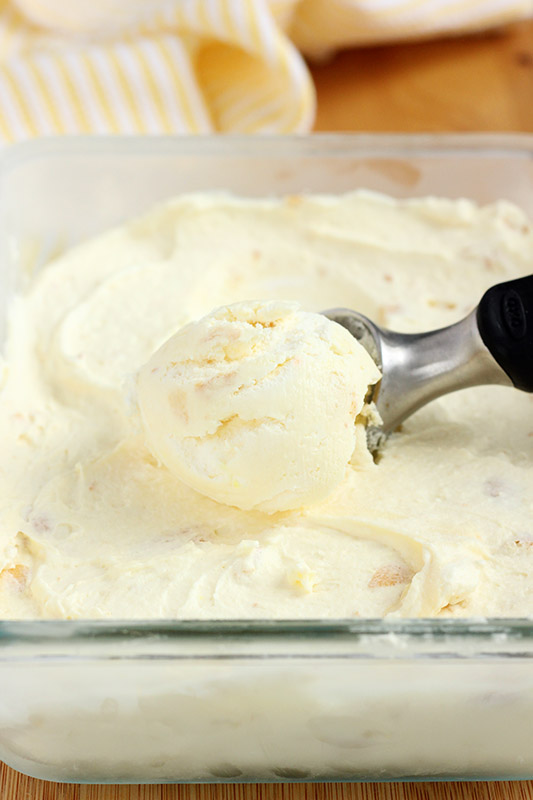 ice cream being scooped onto an ice cream spoon in a clear glass bowl