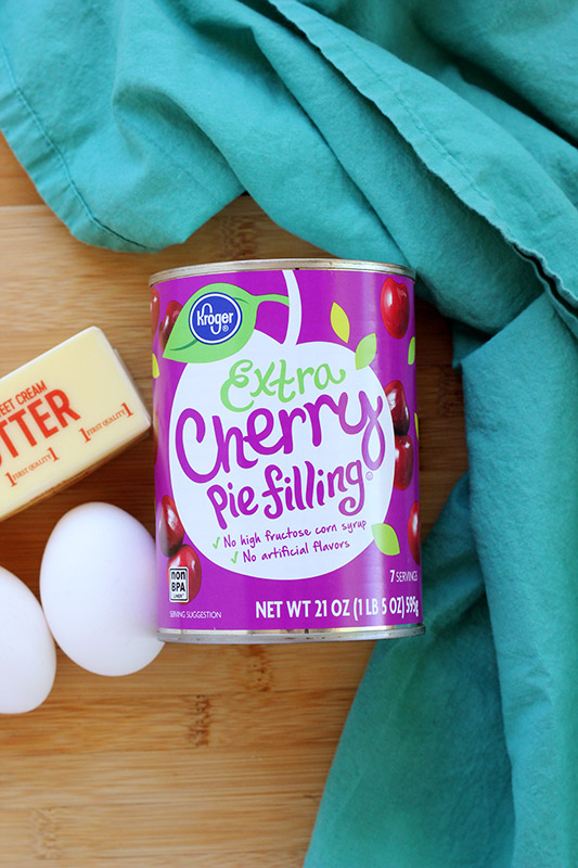 cherry pie filling with eggs and butter on a wooden table