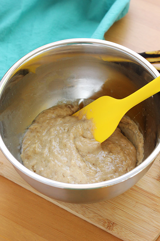 muffin batter in a stainless steel bowl with a spatula