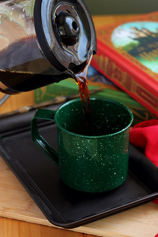 coffee being poured into a green mug