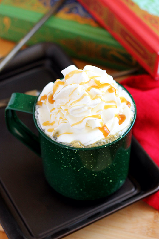 latte topped wtih whipped cream and caramel sauce