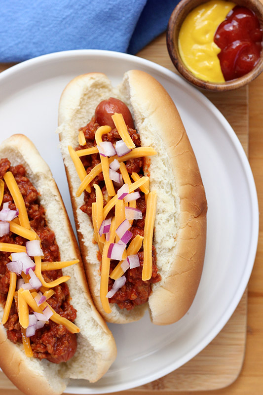 close up of a hot dog topped with chili