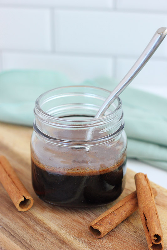 dolce syrup in a glass jar with a spoon
