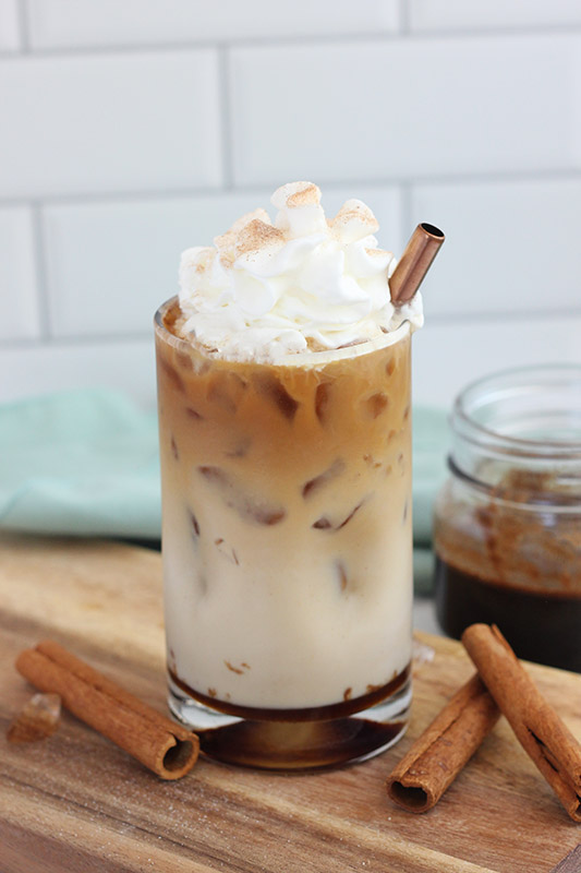 glass filled with dolce latte topped with whipped cream