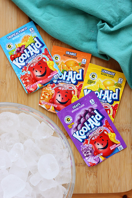 packets of kool aid on a wooden cutting board