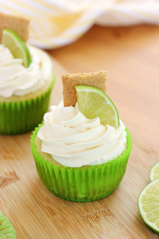 Lime cupcake in a green wrapper topped with graham cracker and lime