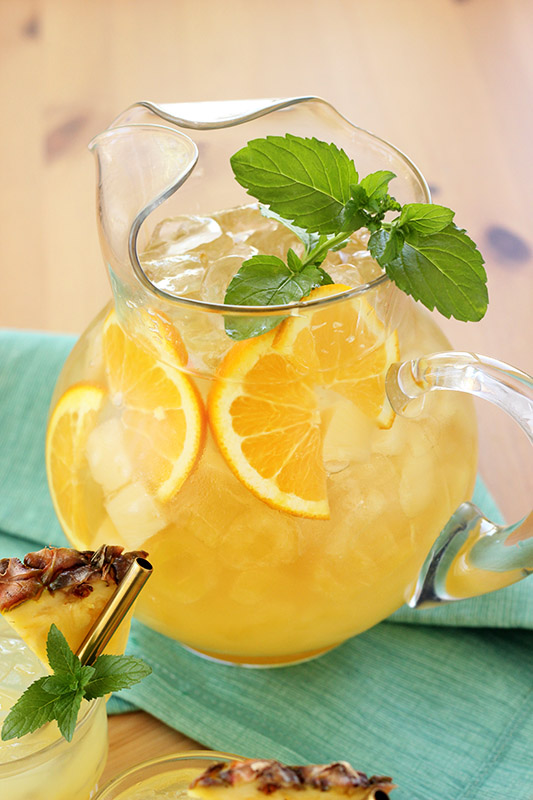 pitcher filled with fresh orange slices and punch