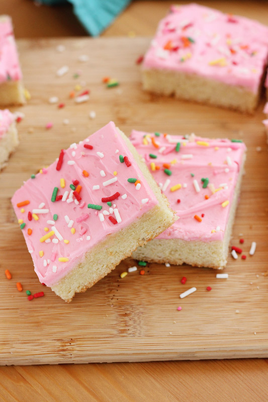 two cookie bars offset on top of each other on a wooden cutting board