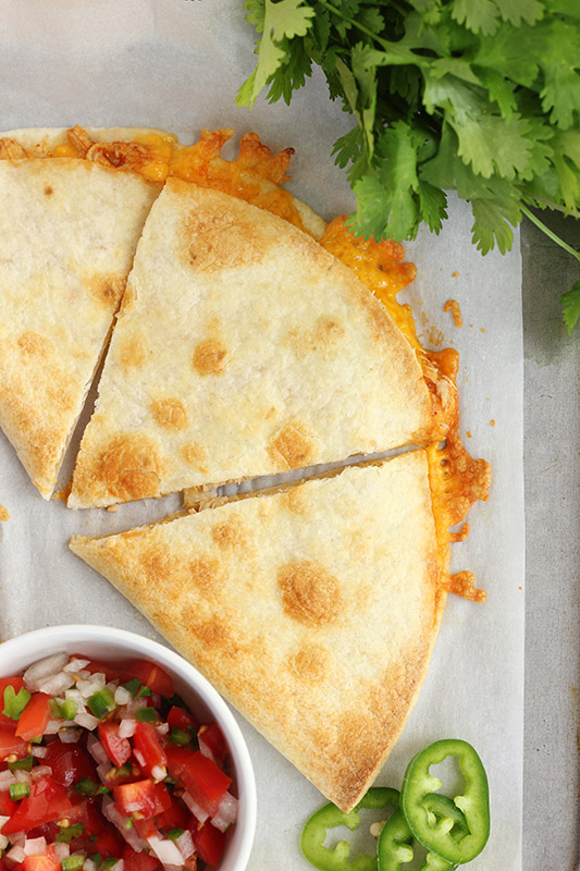 close up of three quesadilla squares with pico on the side