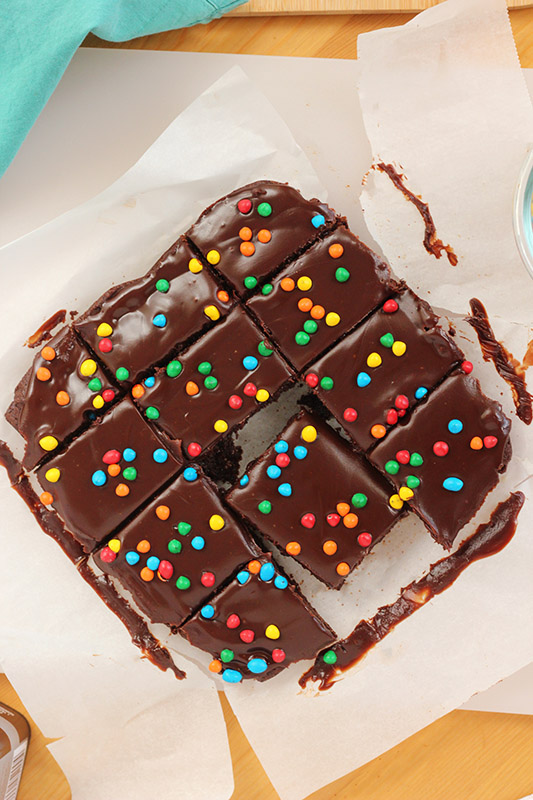 brownies cut into squares on white parchment paper