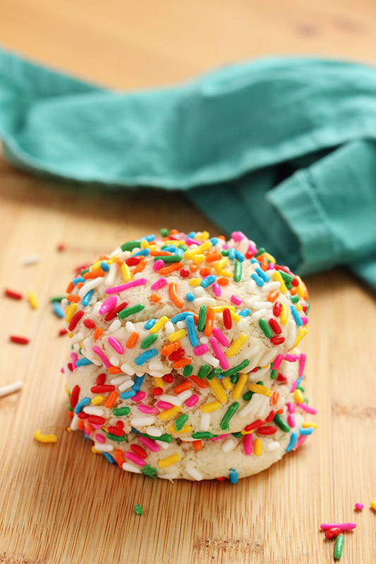 stack of funfetti cookies on a wooden cutting board