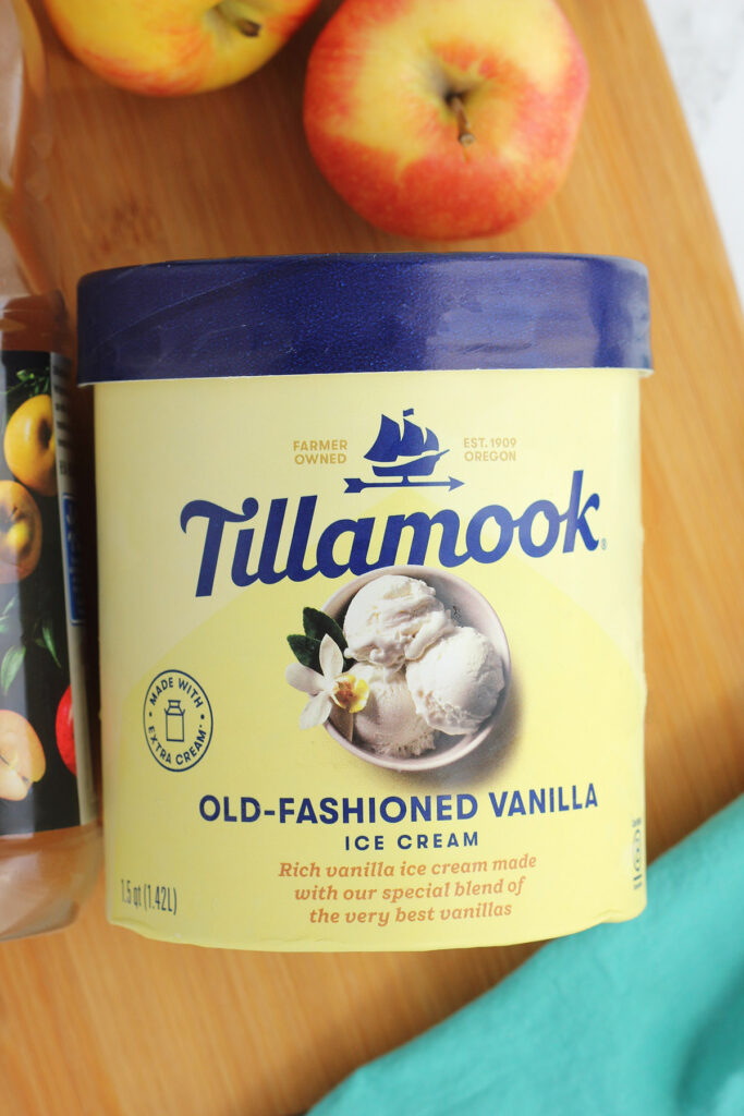 image of a 1.5 pint container of old fashioned vanilla ice cream on a wooden cutting board