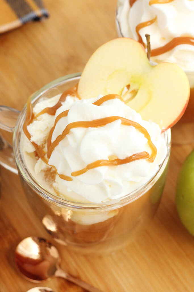 apple ice cream floats topped with whipped cream and caramel sauce