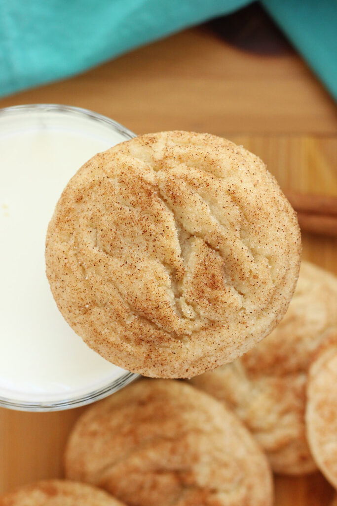 single snickerdoodle cookie balancing on a glass of milk