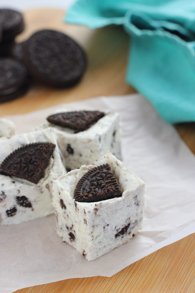 close up image of a single piece of fudge with oreo cookie crumbs