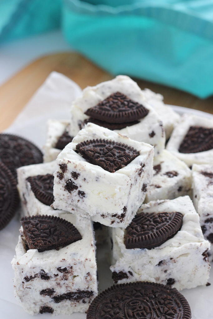Stack of cookies and cream fudge on a white plate