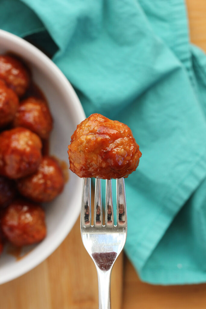 meatball covered in sauce sitting on a fork