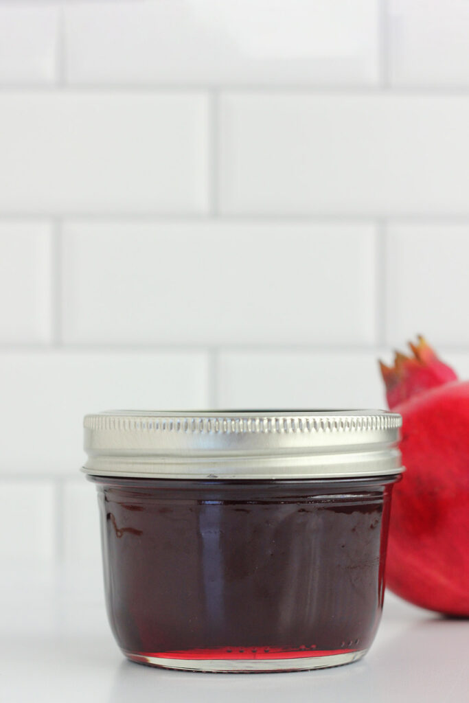 sealed jar of jelly on a white table