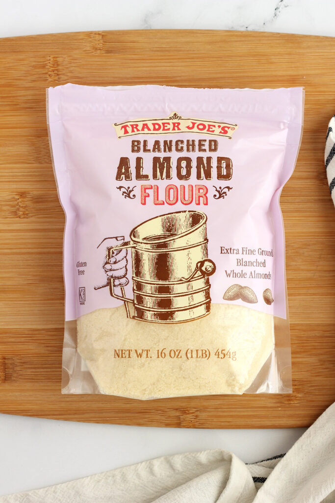 almond flour in a bag sitting on a wooden cutting board