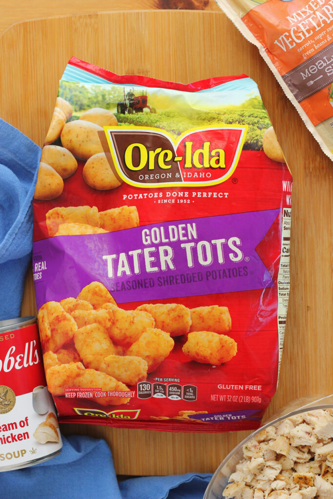 bag of tater tots sitting on a wooden cutting board