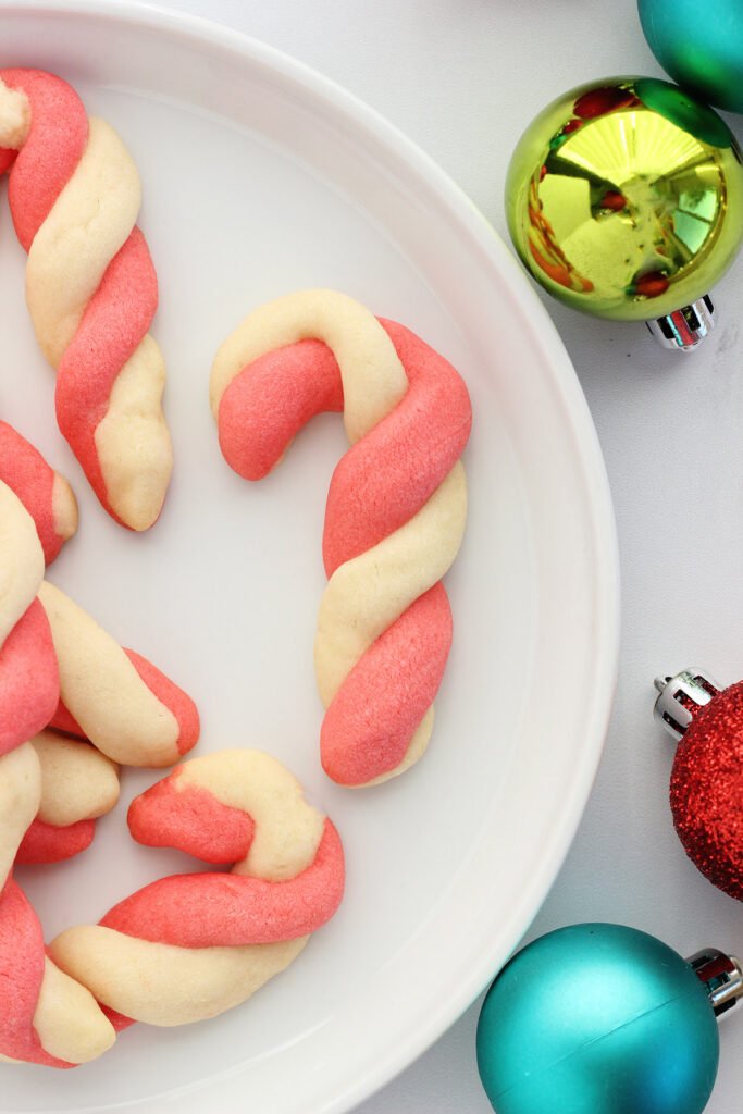 white plate with cookies shaped like candy canes