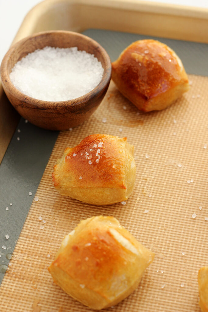 pretzels on a baking tray sprinkled with salt