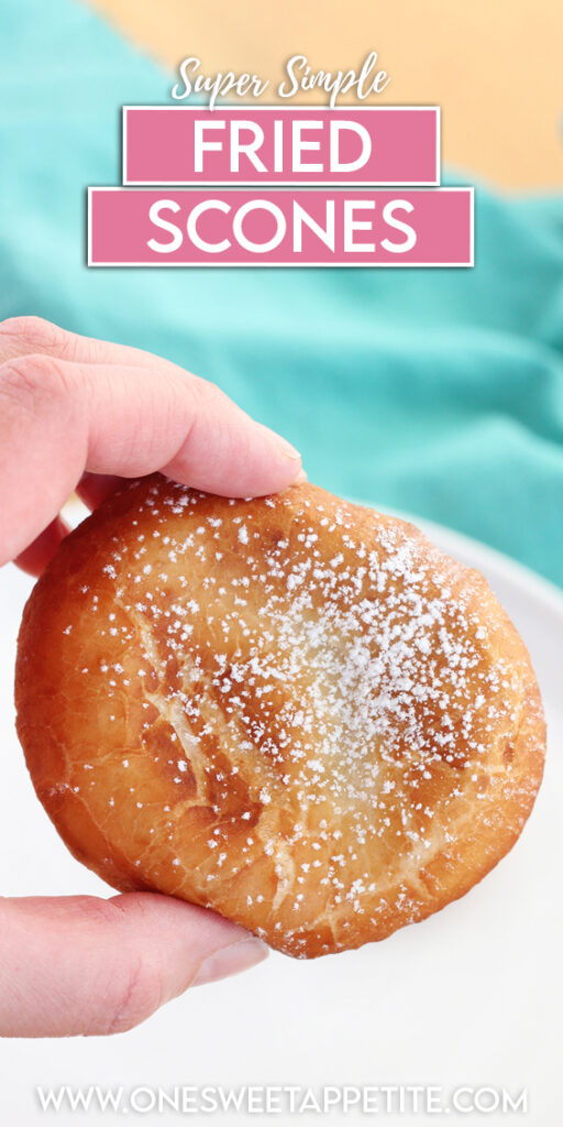 two fried dough rounds on a white round plate and dusted with powdered sugar. The plate is sitting on a wooden board with a teal mapkin in the background