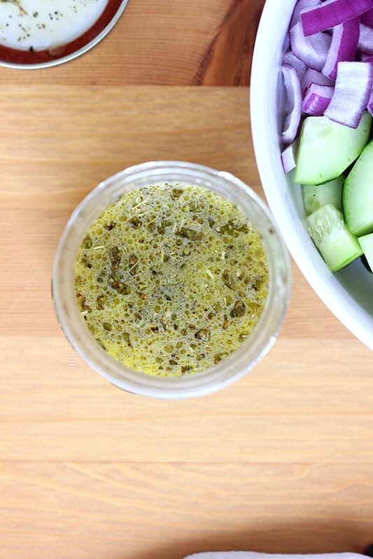 top down image of a mason jar filled with a basic Greek salad dressing