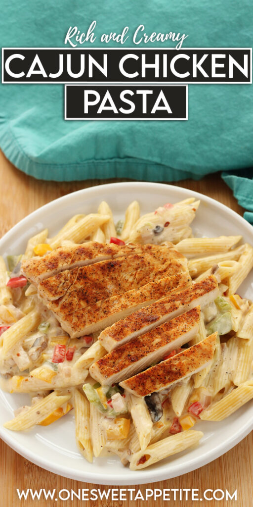 pinterest graphic image of a white plate loaded with pasta and chicken slices. Text overlay reads "rich and cream cajun chicken pasta"