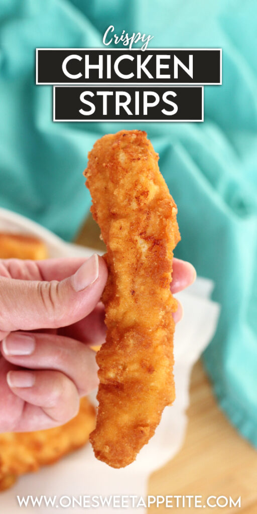 pinterest impage of a fried chicken tender being held over a plate of tenders with text overlay reading "crispy chicken strips"