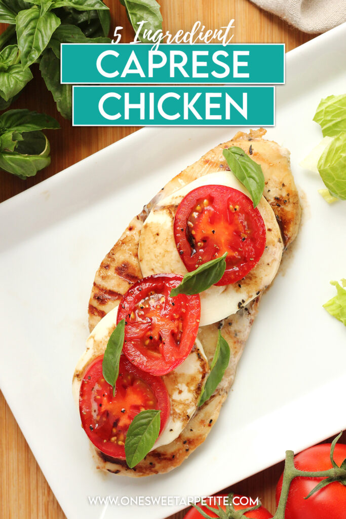 top down image showing a white rectangle plate that has a piece of grilled chicken topped with melted white cheese circles, tomato slices, and fresh basil. A small side salad is off to the side of the plate. The plate is sitting on a wooden cutting board with fresh basil and tomatoes off to the sides. Text overlay reads "5 Ingredient caprese chicken"
