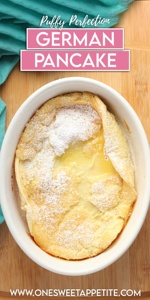 top down image showing a white baking dish that is sitting on a wooden table top with a teal napkin. Inside the dish is a baked pancake that has been dusted with powdered sugar. Text overlay reads "puffy perfection german pancake"