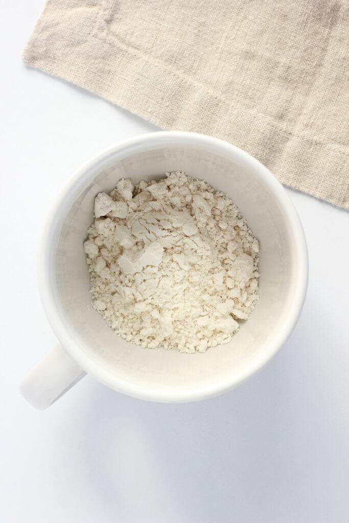 top down image showing a white mug filled with pancake mix