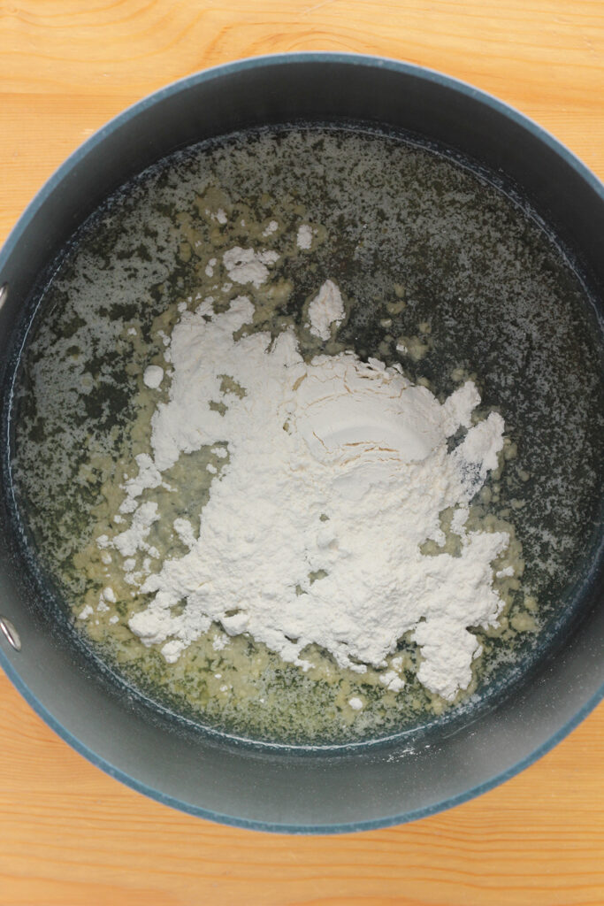 top down image showing a large pot filled with melted butter and flour