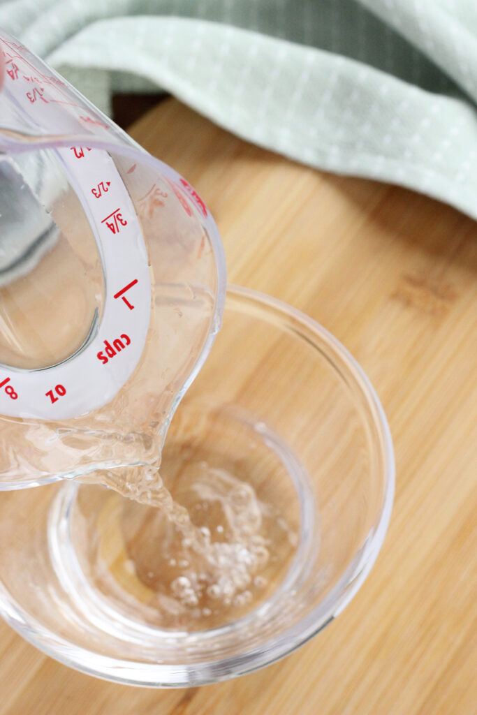 water being poured into a small glass dish