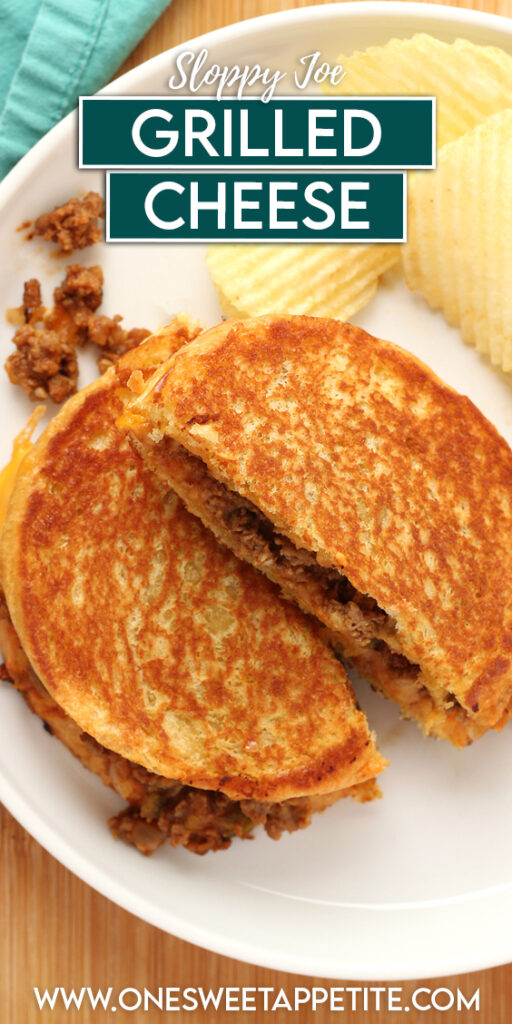 close up image showing a grilled sandwich with meat and cheese that has been cut in half on a white round plate with potato chips and a teal napkin off in the back