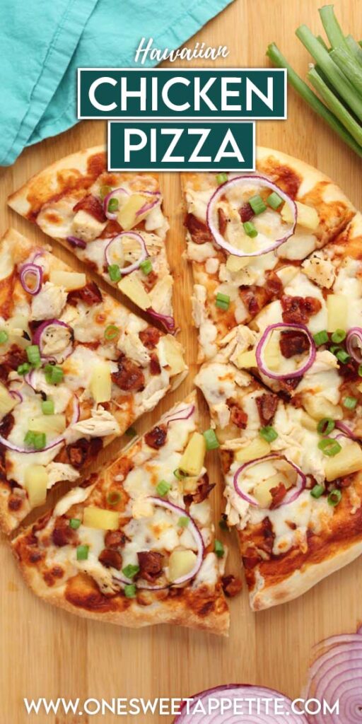 Top down image showing a baked pizza that is topped with cheese, chicken, pineapple ,red onion slices, and bacon. The pizza is sitting on a wooden table top with red onion slices and green onions off the side with a teal napkin. Text overlay reads "Hawaiian chicken pizza"