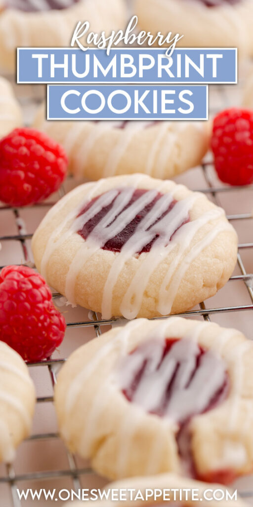 close up image showing a stack of four shortbread cookies with raspberry jam filling and glaze stacked on a tray with more cookies and raspberries. Text overlay reads "Raspberry Thumbprint cookies"