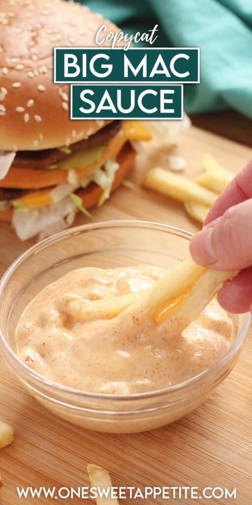 close up of a small glass dish with a sauce that is being dipped into by three french fries. The dish is sitting on a wooden table top with a hamburger off to the side and more fries. Text overlay reads "Copycat Big Mac Sauce"
