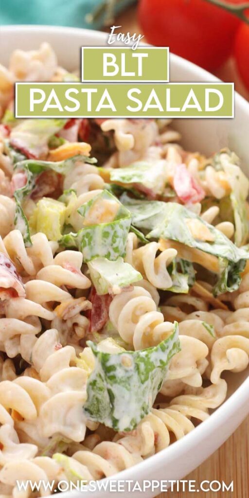 close up image showing a white serving dish filled with a creamy pasta salad that included tomatoes, cheddar cheese, lettuce and bacon. Text overlay reads "easy blt pasta salad"